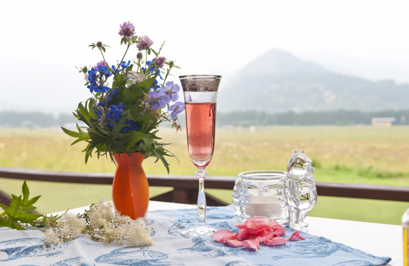 Flowers and rose wine on summer table