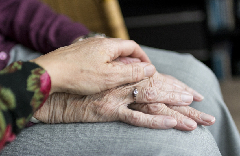 Elderly hands in lap